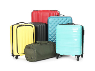 Many colorful suitcases and bag isolated on white