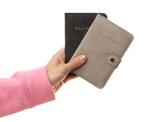 Woman holding passports in bright covers on white background, closeup
