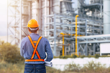 Professional Petroleum Refinery engineer man working building oil and gas power industrial plant.