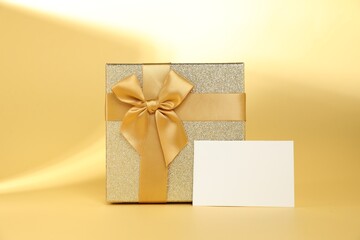 Romantic gift and blank card on beige background. Space for text