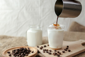 Delicious iced coffee, mocca, and chocolate drinks with coffee beans on white wooden table