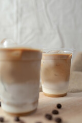 Delicious iced coffee, mocca, and chocolate drinks with coffee beans on white wooden table