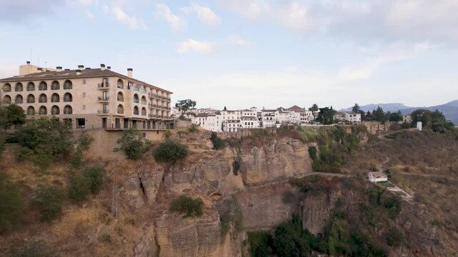 Panoramic view of houses built on the edge of the cliff in the ancient city of Ronda, Andalusia, Spain.