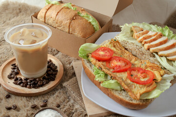 Big breakfast, bread, chicken slice, tomato, lettuce, smoked beef, egg, salad with coffee milk. Bread sandwich fresh and healthy food meal lunch dinner breakfast slices of sandwiches.