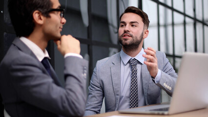 Business people discussing over new business project in office.