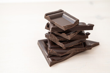 Chocolate chips stacked on white surface