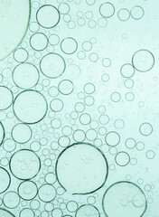 Macro microscope green bubble texture, Close-up Green bubbles and drops oil background . blue green water bubbles, close up golden oil drop for cosmetic...