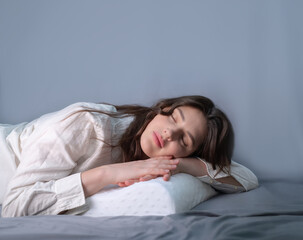 Young woman with an orthopedic pillow for comfortable sleep. Reduces pain from arthritis,...