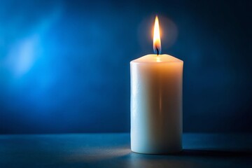 Burning White Candle Dark Blue Background - Mystical Atmosphere Stock Photo
