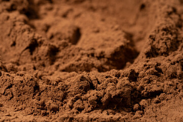 Cocoa powder pile close-up, rotation. Pastry chef. Brown cocoa powder texture circle rotation close-up. Chocolate	
