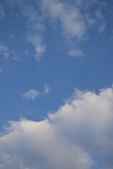 rays of the sun through cirrus clouds against a blue sky, white rainy clouds against a blue sky...