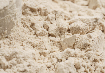 Protein powder in a measuring spoon. Bodybuilding, fitness and lifestyle in the gym. The concept of sports, health and nutrition	
