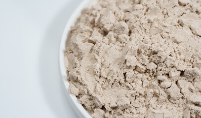 Protein powder in a measuring spoon. Bodybuilding, fitness and lifestyle in the gym. The concept of sports, health and nutrition	
