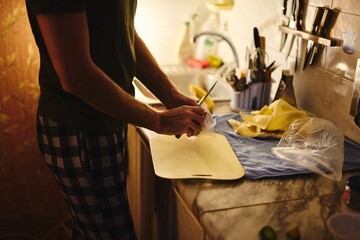 Portrait of a young caucasian man smiling and having a festive dinner in the kitchen