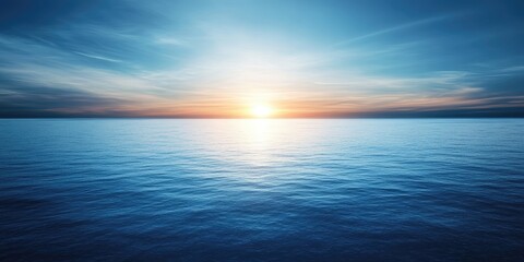Obraz premium Serene sunset over calm blue sea with bright glowing horizon and soft focus effect creating tranquil ambiance with ample copy space on top