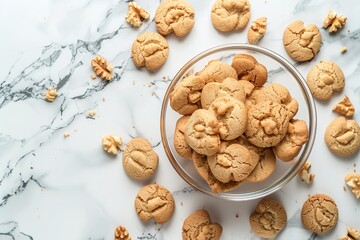 There are some cookies sprinkled around a glass bowl of walnut-shaped cookies on a marble surface, Generative AI.