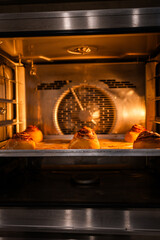 Cinnabons are baked in the oven, bakery kitchen, cinnamon buns and cream, pastry blanks