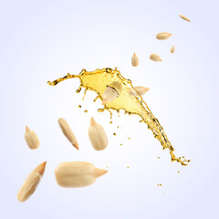 Cooking oil splash and flying sunflower seeds on light blue background