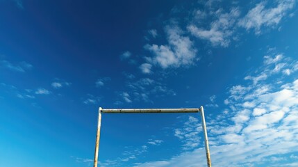 Rugby goal post under a bright blue sky with scattered clouds showcasing the sport's outdoor setting and vibrant atmosphere