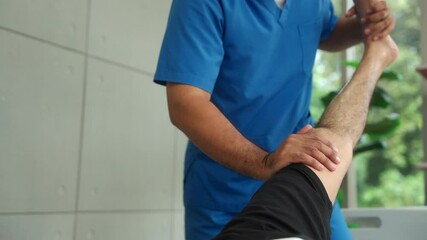 Young physiotherapist man stretching patients leg injury to recover rehabilitation physiotherapy at hospital, young man having leg treatment for wellness medical support concept. - Powered by Adobe