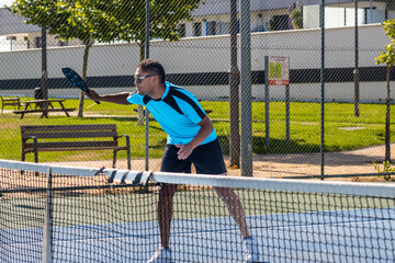 Pickleball player preparing to hit the ball during a match