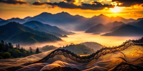 Fototapete Dramatic Black Lace Overlay on Misty Mountain Landscape at Sunset © prapatsorn