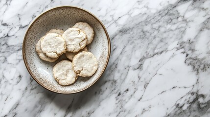 Rustic homemade cookies in a ceramic bowl on a textured marble countertop for a cozy culinary atmosphere