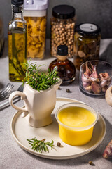 Ghee butter, rosemary and various ingredients creating a flavorful culinary scene