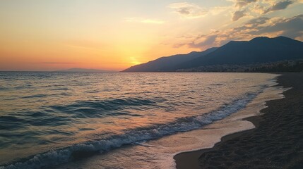 Tranquil Beach Sunset with Soft Waves and Vibrant Orange Sky Reflecting on Calm Water near Mountains and Sandy Shoreline
