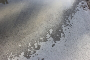 wet footprints on the asphalt