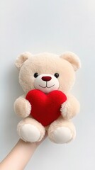 Obraz premium A cute Teddy bear holding a red heart, romantic and adorable, soft textures, white background