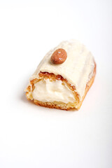 This is a delicious pastry topped with white frosting and an almond