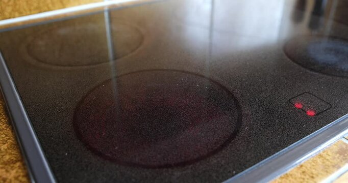 Electric or induction stove being turned on. Glowing red-hot plate, close up shot, real time, no people