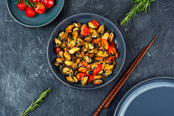 Plate of mussels on a table.