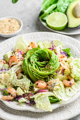 salad with shrimp, cheese and avocado on a marble background