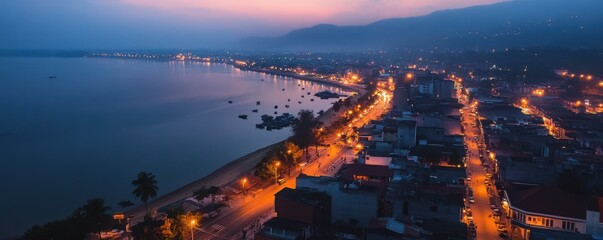 Obraz premium Aerial view of a city illuminated by streetlights during twilight.