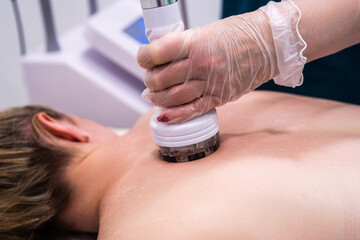 RF massage. Hardware cosmetology. Young woman getting rf lifting procedure in a beauty parlour.