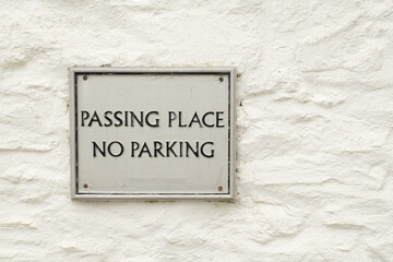 No parking sign and Passing place sign, on wall in Durgan village, Cornwall, England