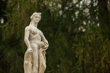 Majestic marble statue at Arkhangelskoye estate surrounded by lush greenery in a tranquil setting