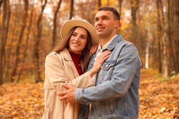 Happy couple spending time together in autumn park