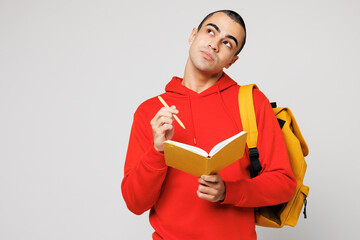 Young minded middle eastern man boy student he wear red casual clothes backpack bag hold book write...
