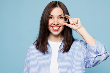 Young happy smiling woman she wear shirt casual clothes hold in hand cover eye with invisible...