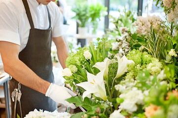 A florist carefully cuts flowers in a flower shop. The interior is filled with vibrant blooms, detailed textures, a calm atmosphere, harmonious composition, and cinematic lighting.