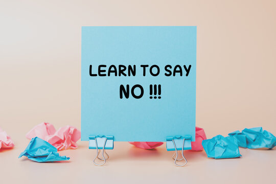 Learn to Say No: text on a sticky note. Ideal for Self-Help, Personal Growth, Setting Boundaries and Assertiveness Training. Blue Note on a Neutral Background