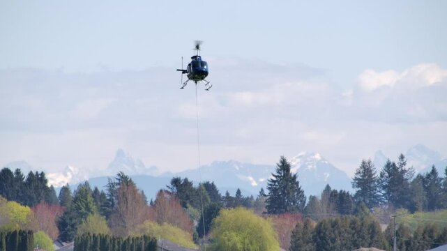 Helicopter Flying with Cable Attached for Load Hoisting SLOMO