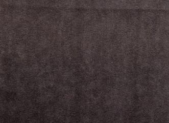 A dark brown carpet with a pattern of small dots