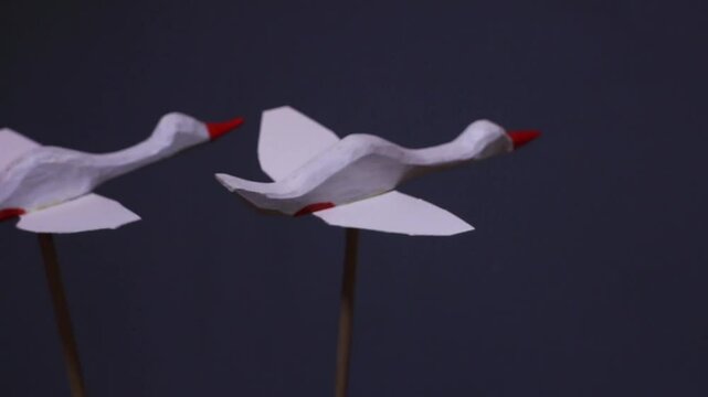 a pair of graceful white swans in flight