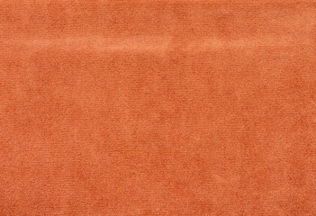 The orange fabric has a rough texture and is folded in half