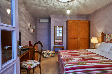 Old hotel room interior style with bed mirror carpet design.
