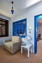 Blue hotel room interior concept, white bed and bathroom style.